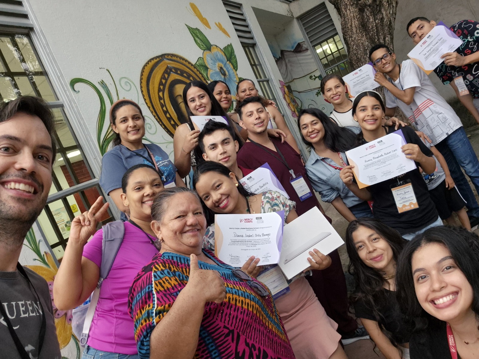 Entrepreneurs holding their Rebel Business School certificates after graduating